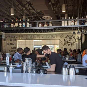 Hash Kitchen Arcadia - View from the patio to the inside. DJ is under where it says "Turn It Up". - Breakfast & Brunch Near Me - Phoenix, Arizona