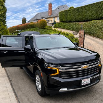 VIP Livery - Black Chevrolet Suburban prepared for private chauffeur service, with the passenger door open for a smooth, comfortable departure. - Town Car Service Near Me - West Hills, California VIP Livery - Black Chevrolet Suburban prepared for private chauffeur service, with the passenger door open for a smooth, comfortable departure. - Town Car Service Near Me - West Hills, California