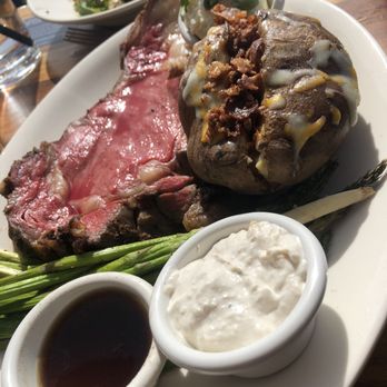 BJ's Restaurant & Brewhouse - Prime Rib with loaded baked potato and roasted asparagus. With Tomato and Mozzarella salad - New American Near Me - Downey, California