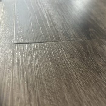 Empire Today - Uneven flooring, causing top layer of the plank to begin to peel. - Flooring Near Me Empire Today - Uneven flooring, causing top layer of the plank to begin to peel. - Flooring Near Me