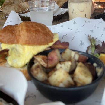 The Table - Pimento cheese, egg, bacon on a croissant with breakfast potatoes and a iced caramel latte. - Bakeries Near Me - Asheboro, North Carolina The Table - Pimento cheese, egg, bacon on a croissant with breakfast potatoes and a iced caramel latte. - Bakeries Near Me - Asheboro, North Carolina