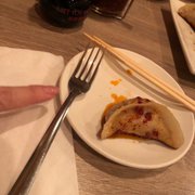 Photo of Moon Palace Express - Chicago, IL, United States. Pork Pot Sticker with table condiments: Vinegar and chili sauce.