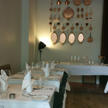 Atelier by Radex - Striking Copper Pot Display on the Back Wall - French Near Me - Denver, Colorado