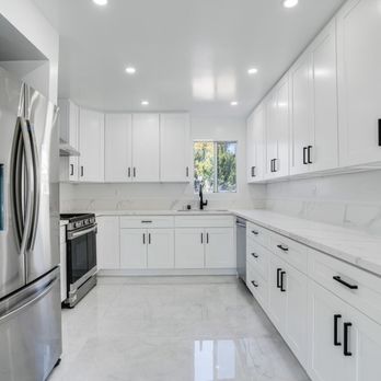 KBS Design And Build - a kitchen with white cabinets and stainless steel appliances - General Contractors Near Me KBS Design And Build - a kitchen with white cabinets and stainless steel appliances - General Contractors Near Me