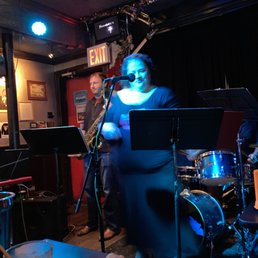 a man playing a saxophone and a woman singing