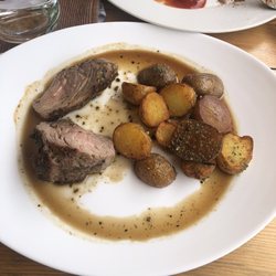 Pork Medallions in an herb butter with potatoes.