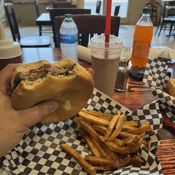 Grizzly Burger House - a hand holding a half eaten sandwich - Cafes Near Me - Savoy, Texas Grizzly Burger House - a hand holding a half eaten sandwich - Cafes Near Me - Savoy, Texas