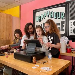 Happy Hour Vintage - The owners of Happy Hour Vintage, Rebecca and Jake, with two of their daughters on opening day, 3/23/24.