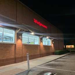 the outside of a walgreens store at night