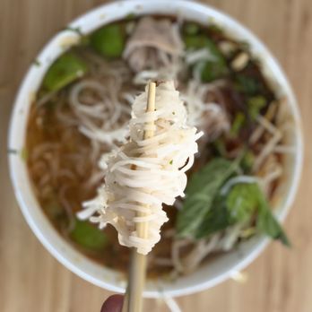 Holy Basil Pho - a person holding chopsticks over a bowl of noodles - Vietnamese Near Me - Oakland, California Holy Basil Pho - a person holding chopsticks over a bowl of noodles - Vietnamese Near Me - Oakland, California