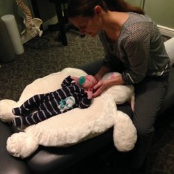 Active Health Chiropractic - Another happy baby, calm & connected. Infants love getting adjusted, & sometimes even sleep through the process.