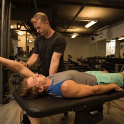 Body By Robbie - Robbie performing manual therapy on a client's shoulder.