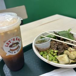 Let’s Eat Rice & Grill - Thai Iced Tea Bibimbap - White rice, beef, zucchini, edamame, mushrooms, seaweed salad, peanut kale, fried garlic, and Thai chili sauce