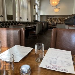 a table with a menu and glasses on it a table with a menu and glasses on it