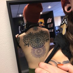 Black Opal Tattoo Studio - Stencil and large mandala with flowers across upper back by Deke.
