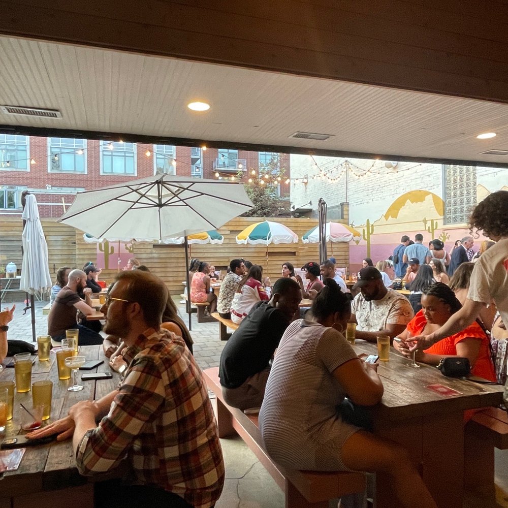 a group of people sitting at a bar a group of people sitting at a bar