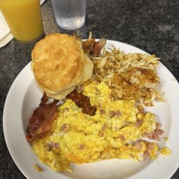 Ham and cheese mixed in eggs with side of hash browns, biscuit, and bacon Ham and cheese mixed in eggs with side of hash browns, biscuit, and bacon