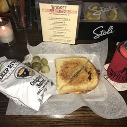 Cheesesteak grilled cheese with side of pickles and kettle chips
