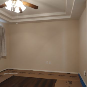 Latigo Construction - a living room with a ceiling fan - Plumbing Near Me Latigo Construction - a living room with a ceiling fan - Plumbing Near Me