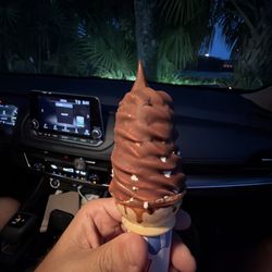 Vanilla ice cream on a cake cone dipped in chocolate