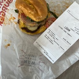 a sandwich on a wrapper with a receipt a sandwich on a wrapper with a receipt