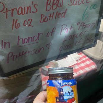 Ptrain's Ca BBQ - a hand holding a jar of bbq sauce - Barbeque Near Me Ptrain's Ca BBQ - a hand holding a jar of bbq sauce - Barbeque Near Me