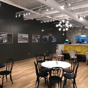 Mezza Luna - a dining area with black chairs and a white table - Italian Near Me - Holmdel, New Jersey Mezza Luna - a dining area with black chairs and a white table - Italian Near Me - Holmdel, New Jersey