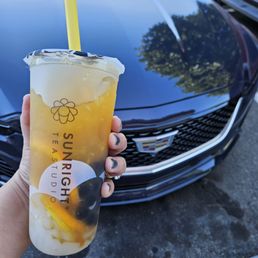 Passion tea with fresh squeezed orange juice, boba and lychee jelly.
