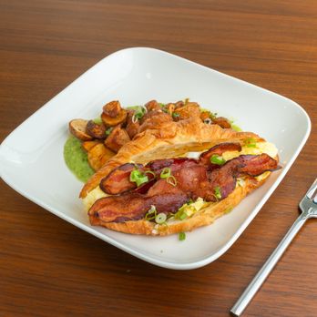 Pistachio Kitchen - Pistachio's Bacon & Egg Croissant served with roasted house potatoes & tomatillo sauce - Breakfast & Brunch Near Me - San Francisco, California Pistachio Kitchen - Pistachio's Bacon & Egg Croissant served with roasted house potatoes & tomatillo sauce - Breakfast & Brunch Near Me - San Francisco, California