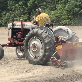 Bosch Landscaping - a man driving a tractor with a trailer attached to it - Landscaping Near Me - Graytown, Ohio Bosch Landscaping - a man driving a tractor with a trailer attached to it - Landscaping Near Me - Graytown, Ohio