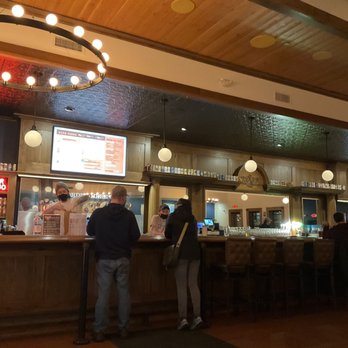 Indeed Brewing Company - Taproom with fancy lighted sign and beautiful woodwork. - Breweries Near Me - Milwaukee, Wisconsin