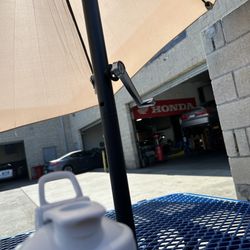 Honda Guys - A table and bench with umbrella so you can wait.