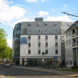 City Park Hotel - Front links Parkanlage im Vordergrund Straßenbahn
