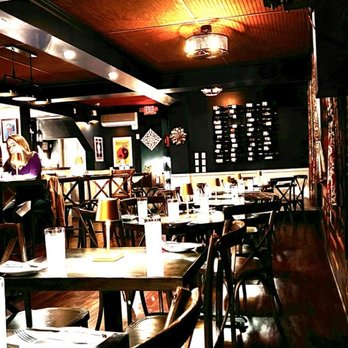 Bodega Tapas & Wine - Warm lighting with individual table lamps set the cozy tone. - Tapas/Small Plates Near Me - Wake Forest, North Carolina