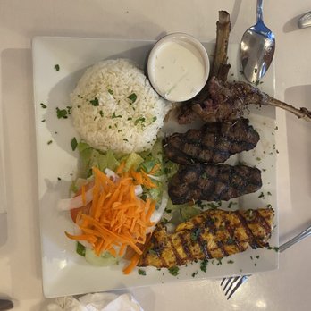 Bodrum Restaurant - This dish is the mixed grill as you can see 2 eaten lamb chops 1 Piece of chicken and 2 kofte "beef"  rice and salad. Yummy - Mediterranean Near Me - Venice, Florida