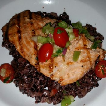Bar Bistro - Chef's special: coho salmon topped with tomato/pepper relish, accompanied by black rice risotto. - Cocktail Bars Near Me - Tacoma, Washington Bar Bistro - Chef's special: coho salmon topped with tomato/pepper relish, accompanied by black rice risotto. - Cocktail Bars Near Me - Tacoma, Washington