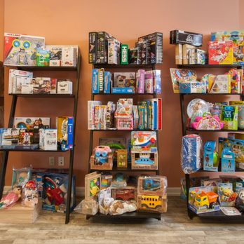 Genus Boni - a shelf of toys and books - Toy Stores Near Me - Metuchen, New Jersey