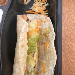 a tortilla with lettuce and cheese