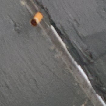Bell Flatirons Apartments - Cigarette butts on rook above the patio - Apartments Near Me - Louisville, Colorado