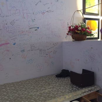 Pho Saigon - a table and chairs in a room with writing on the wall - Vietnamese Near Me - Delta, British Columbia Pho Saigon - a table and chairs in a room with writing on the wall - Vietnamese Near Me - Delta, British Columbia