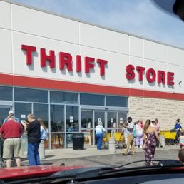 People waiting in line for the store to open at noon on a Sunday