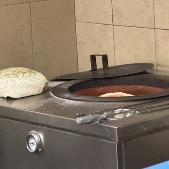 Al Humza - a pan of food cooking on a stove - Halal Near Me - Staten Island, New York Al Humza - a pan of food cooking on a stove - Halal Near Me - Staten Island, New York