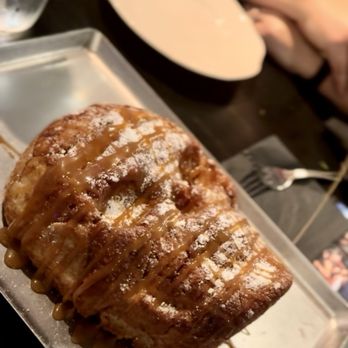 Voodoo Bayou - Skull monkey bread after the server drizzled in caramel sauce. - Cocktail Bars Near Me - Orlando, Florida
