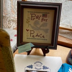 Blueberry Hill Stitchery - Store display of beautiful peace stitched design