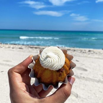 Nothing Bundt Cakes - a person holding a bundt cake on the beach - Bakeries Near Me - North Miami Beach, Florida Nothing Bundt Cakes - a person holding a bundt cake on the beach - Bakeries Near Me - North Miami Beach, Florida