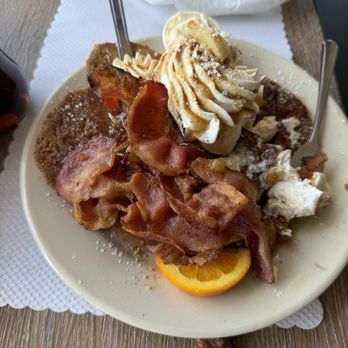 The Breakfast Nook - C cinnamon banana French toast with whip, cream, and bacon added on top. - Breakfast & Brunch Near Me - North Haven, Connecticut