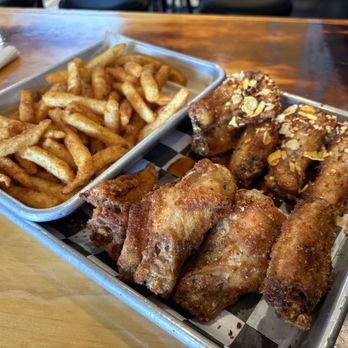 Foghorn Taproom - Seasoned Fries, Hot Honey Crunch Chicken Wings (top/back), Dry Spice Chicken Wings (bottom/front) - Chicken Wings Near Me - San Francisco, California Foghorn Taproom - Seasoned Fries, Hot Honey Crunch Chicken Wings (top/back), Dry Spice Chicken Wings (bottom/front) - Chicken Wings Near Me - San Francisco, California