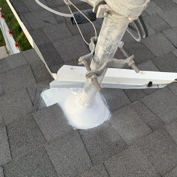 ProWest - A satellite dish mount is secured to a shingled roof with metal brackets and bolts, with wiring connected to the dish. - Roofing Near Me - Mesa, Arizona