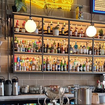 Roger's Liquid Oasis - a bar with a neon sign - Wine Bars Near Me - Edgewater, Colorado