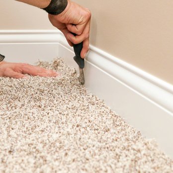 Monavé Flooring & Design - a man using a hammer to trim a baseboard - Flooring Near Me - Glendale, California Monavé Flooring & Design - a man using a hammer to trim a baseboard - Flooring Near Me - Glendale, California